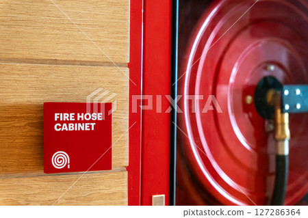 Fire Safety Concept, Fire extinguisher, Fire protection cabinet with fire hydrant and hose reel in public building corridor. 127286364