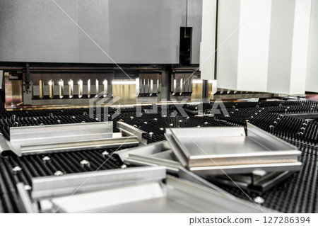 Automatic metal sheet bending machine at work in factory. CNC Panel Bender (Press Arm Type) 127286394