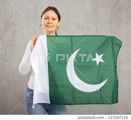 Excited positive girl with Pakistan flag rooting for your favorite team 127287226