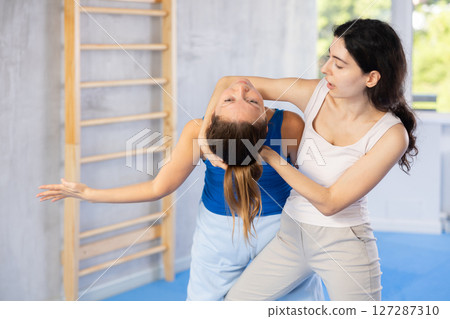 Self-defense enthusiasts practice leg sweep Self-defense enthusiasts practice leg sweep 127287310