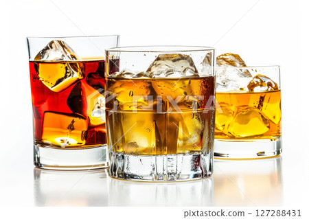 Three glasses of alcohol with ice cubes in them 127288431
