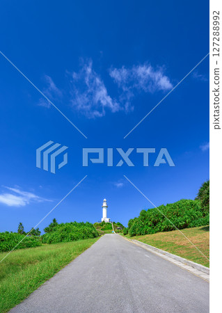 The road to Ishigaki Okanzaki Lighthouse, illuminated against the blue sky The road to Ishigaki Okanzaki Lighthouse, illuminated against the blue sky 127288992