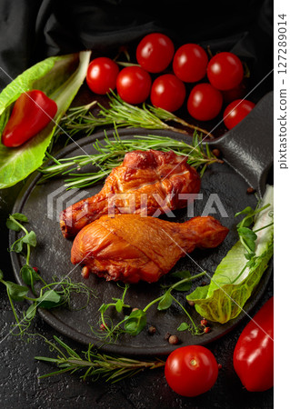 Smoked chicken drumsticks with greens and vegetables. 127289014