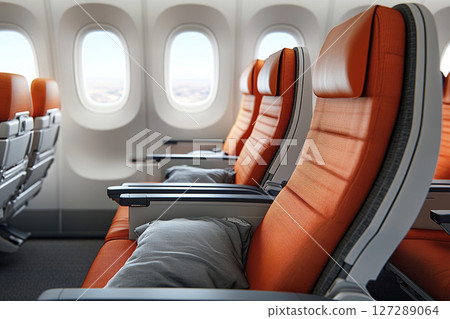 Interior of a passenger airplane cabin with seats and windows. Comfortable seats with pillows in the airplane. 127289064