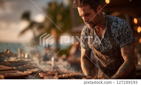 Focused Chef Grilling Seafood and Meat at Sunset Beach BBQ 127289193