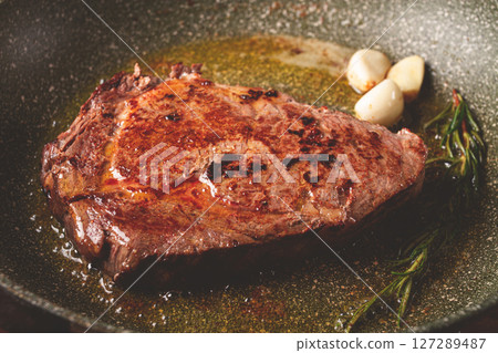 fried steak, beef steak, rib eye steak, in a frying pan, top view, no people 127289487