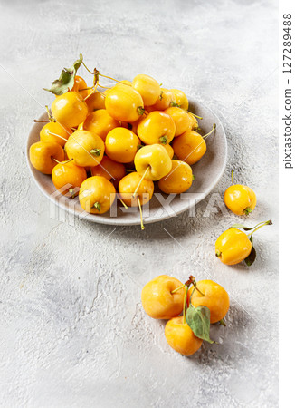 yellow small apples, Chinese variety, on a gray plate, top view, no people, yellow small apples, Chinese variety, on a gray plate, top view, no people, 127289488