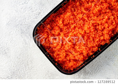 container with orange caviar, flying fish, Tobiko, on the table, caviar for rolls and sushi, close-up, container with orange caviar, flying fish, Tobiko, on the table, caviar for rolls and sushi, close-up, 127289512