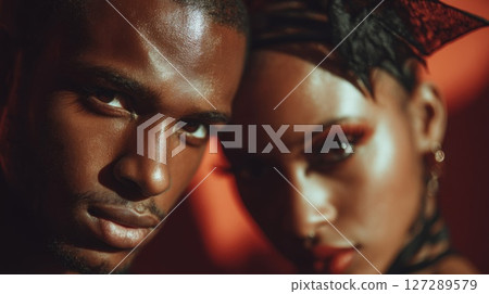 Closeup Portrait of a Sensual Couple Against Red Background 127289579