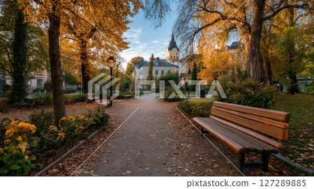Autumn Park Pathway with Golden Leaves and Building 127289885