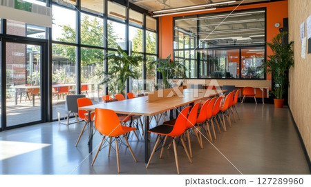 Modern Office Interior with Orange Chairs and Large Windows 127289960