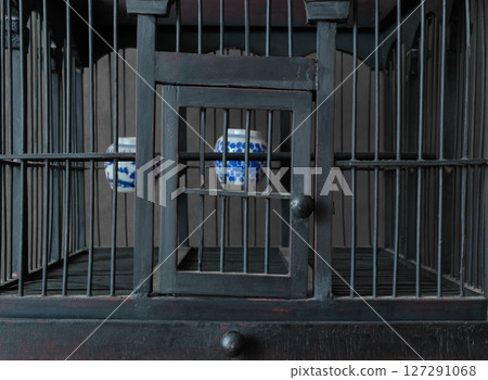 Vintage and Old Wooden Bird Cage with Water Cups 127291068