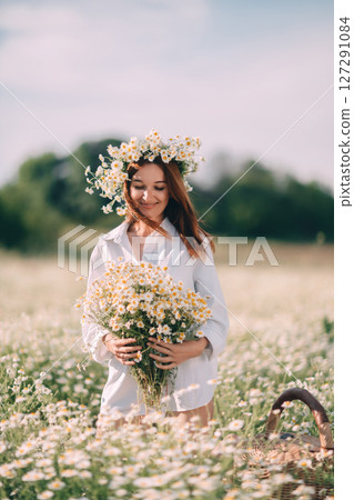 Daisies Woman Flowers: Girl collects summer bouquet in field, sunny day, enjoying nature, with basket. 127291084