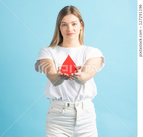 Woman holding red blood drop mockup as symbol of blood donation Woman holding red blood drop mockup as symbol of blood donation 127291196