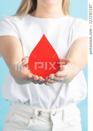 Woman holding red blood drop mockup as symbol of blood donation Woman holding red blood drop mockup as symbol of blood donation 127291197