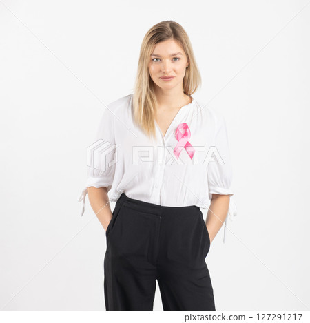Woman with pink ribbon as a symbol of breast cancer 127291217