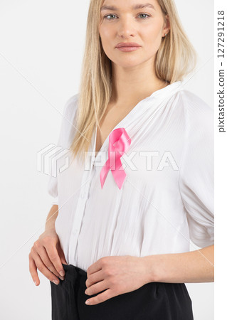 Woman with pink ribbon as a symbol of breast cancer 127291218