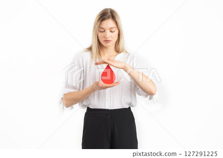 Woman holding red blood drop mockup as symbol of blood donation Woman holding red blood drop mockup as symbol of blood donation 127291225