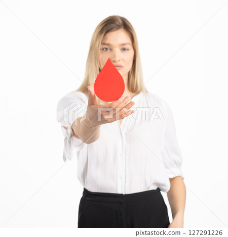 Woman holding red blood drop mockup as symbol of blood donation Woman holding red blood drop mockup as symbol of blood donation 127291226