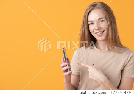 Smiling Woman with Smartphone 127291489