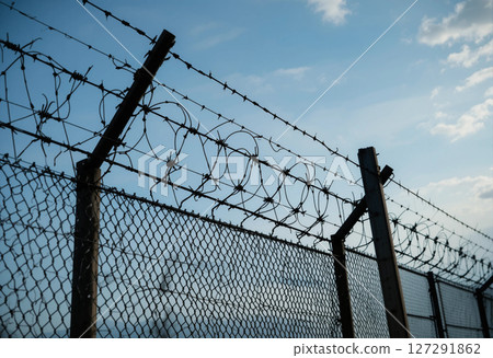 barbed wire fence on a fence 127291862