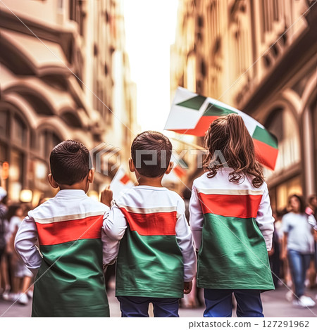 Three children are standing in a city street holding flags 127291962