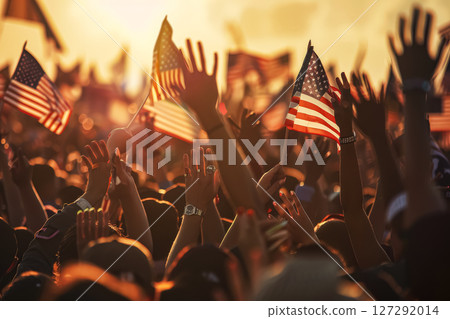Crowd of people are holding up American flags. Crowd of people are holding up American flags. 127292014