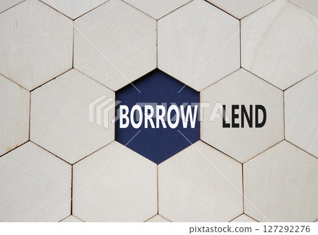 Lend or Borrow symbol. Concept word Lend or Borrow on wooden comb puzzle. Beautiful deep blue background. Business and Lend or Borrow concept. Copy space 127292276