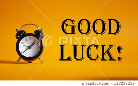 Good luck symbol. Beautiful orange background with alarm clock. Business and Good luck concept. Copy space. Good luck symbol. Beautiful orange background with alarm clock. Business and Good luck concept. Copy space. 127292286