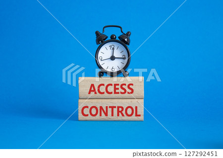 Access Control symbol. Concept words Access Control on wooden blocks. Beautiful blue background with alarm clock. Business and Access Control concept. Copy space. 127292451
