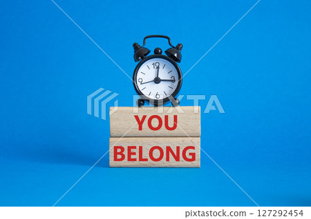 You belong symbol. Concept words You belong on wooden blocks. Beautiful blue background with alarm clock. Business and You belong concept. Copy space. You belong symbol. Concept words You belong on wooden blocks. Beautiful blue background with alarm clock. Business and You belong concept. Copy space. 127292454