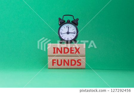 Index Funds symbol. Concept words Index Funds on wooden blocks. Beautiful green background with alarm clock. Business and Index Funds concept. Copy space. Index Funds symbol. Concept words Index Funds on wooden blocks. Beautiful green background with alarm clock. Business and Index Funds concept. Copy space. 127292456