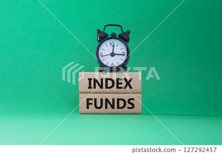 Index Funds symbol. Concept words Index Funds on wooden blocks. Beautiful green background with alarm clock. Business and Index Funds concept. Copy space. Index Funds symbol. Concept words Index Funds on wooden blocks. Beautiful green background with alarm clock. Business and Index Funds concept. Copy space. 127292457