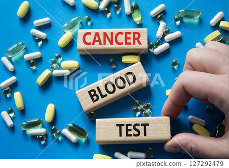 Cancer Blood Test symbol. Concept word Cancer Blood Test on wooden blocks. Doctor Hand. Beautiful blue background with pills. Medicine and Cancer Blood Test concept. Copy space 127292479