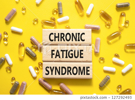 Chronic Fatigue Syndrome symbol. Concept word Chronic Fatigue Syndrome on wooden blocks. Beautiful yellow background with pills. Medicine and Chronic Fatigue Syndrome concept. Copy space Chronic Fatigue Syndrome symbol. Concept word Chronic Fatigue Syndrome on wooden blocks. Beautiful yellow background with pills. Medicine and Chronic Fatigue Syndrome concept. Copy space 127292493