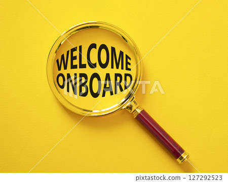 Welcome onboard symbol. Magnifying Glass with Concept word Welcome onboard. Beautiful yellow background. Business and Welcome onboard concept. Copy space 127292523
