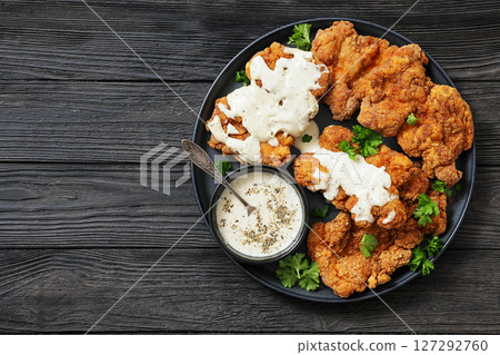 Deep fried Southern chicken thighs with milk gravy 127292760
