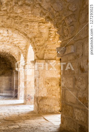 Brick stone archway with receding path 127293025