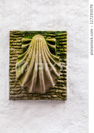 Shell symbol mounted on brick wall along the Camino de Santiago pilgrimage route in Spain Shell symbol mounted on brick wall along the Camino de Santiago pilgrimage route in Spain 127293076