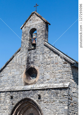 Bells toll in the serene stone chapel in Roncevaux along the Camino de Santiago, French Pyrenees 127293096