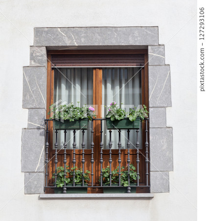 Charming wooden window with flower box in a rustic building during daylight Charming wooden window with flower box in a rustic building during daylight 127293106