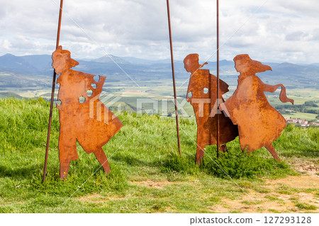Metal sculptures of pilgrims on Alto del Perdon on the Camino de Santiago surrounded by scenic landscape 127293128