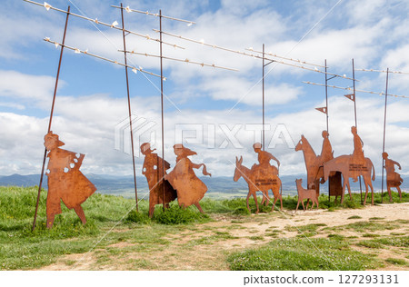 Metal sculptures of pilgrims on Alto del Perdon on the Camino de Santiago surrounded by scenic landscape Metal sculptures of pilgrims on Alto del Perdon on the Camino de Santiago surrounded by scenic landscape 127293131