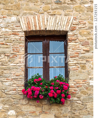Charming wooden window with flower box in a rustic building during daylight 127293155