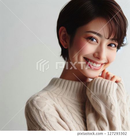 Beautiful Japanese woman with short hair, wearing an elegant sweater, smiling warmly while touching her chin, captured with soft natural lighting , white background 127293302