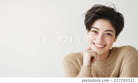 Elegant close-up of a Japanese woman with natural skin tone, smiling in a beige sweater, high-resolution professional photography with magazine-style aesthetics. 127293311