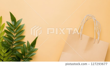 Neutral beige background with paper bag and plant, styled for clean eco branding visuals, stock image contest winner, perfect for promotional banners. 127293677