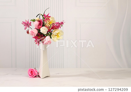 Abstract floral arrangement. Still life with beautiful columbine flowers, cream rose and wild rose in vase on elegant modern table, template for your design with place for text, minimalist beauty 127294209