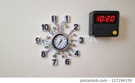 Modern wall clock design with digital and analog elements. 127296339
