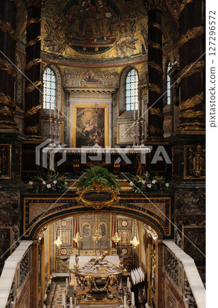 Elevated chapel and sculptural tomb in Basilica of Saint Mary Major featuring Christmas garlands detailed wall art and religious statuary under gold-painted architectural arches. High quality photo 127296572